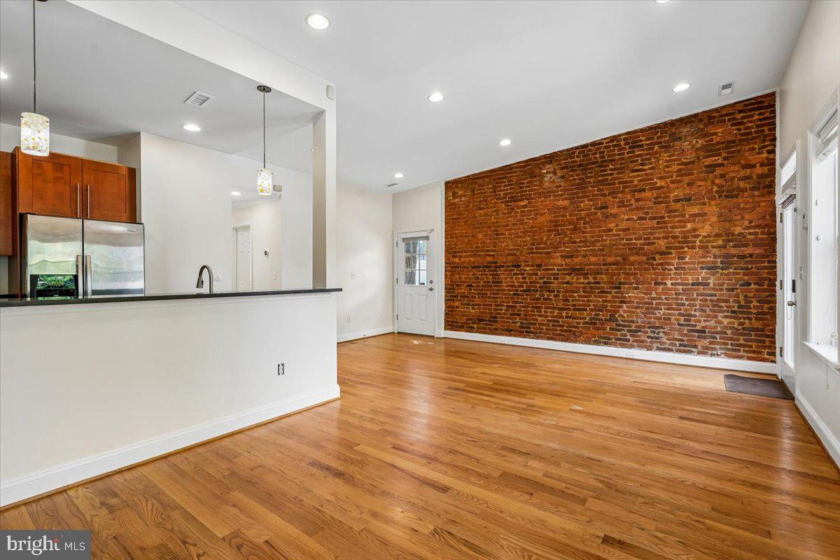 1339 C Street Northeast Washington, DC 20002 - Photo 7 of 24 a view of an empty room with wooden floor and a window