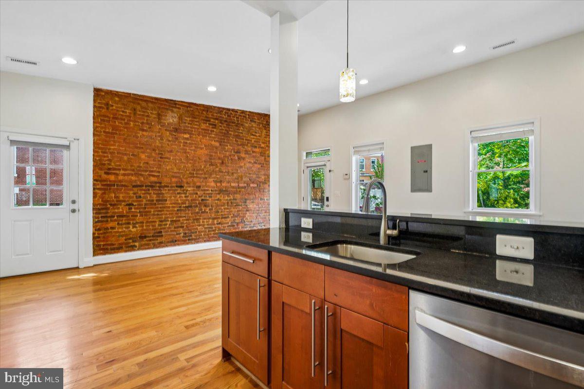 1339 C Street Northeast Washington, DC 20002 - Photo 9 of 24 a kitchen with granite countertop a sink a counter space and windows