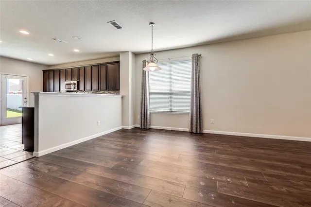 a living room with furniture wooden floor and a large window