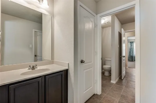 a bathroom with a granite countertop bathtub shower and toilet
