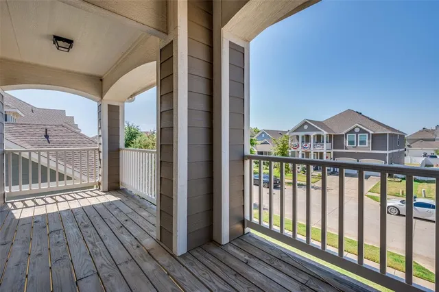 a view of wooden balcony with a floor to ceiling window