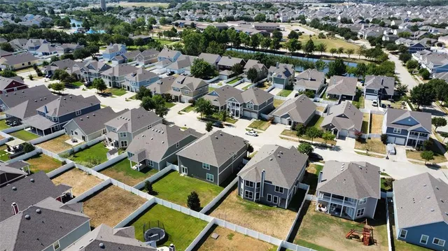an aerial view of a houses with a yard
