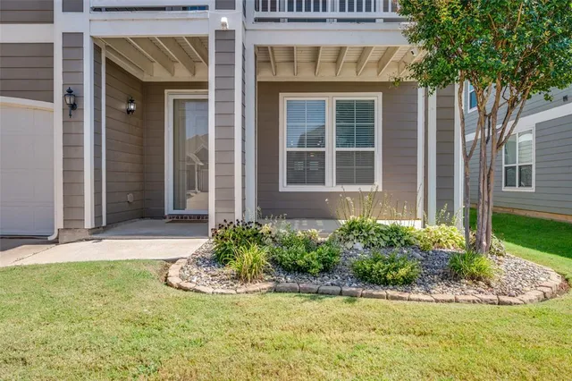 front view of a brick house with a yard