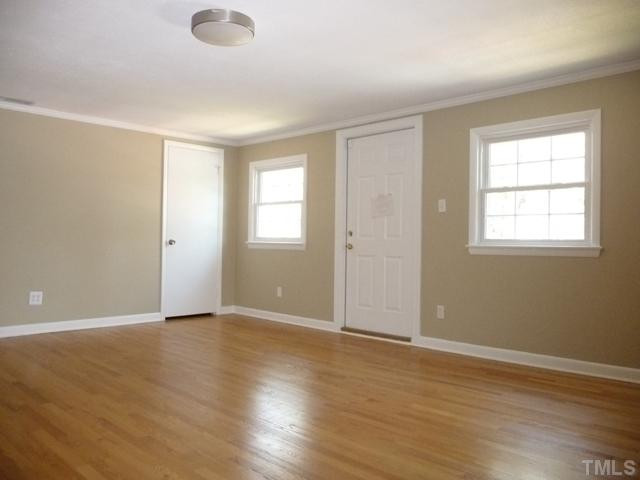 122 Lord Ashley Road Raleigh, NC 27610 - Photo 16 of 25 One of three upstairs bedrooms, the biggest has a non-functional exterior door that once led to exterior stairs that were later removed.