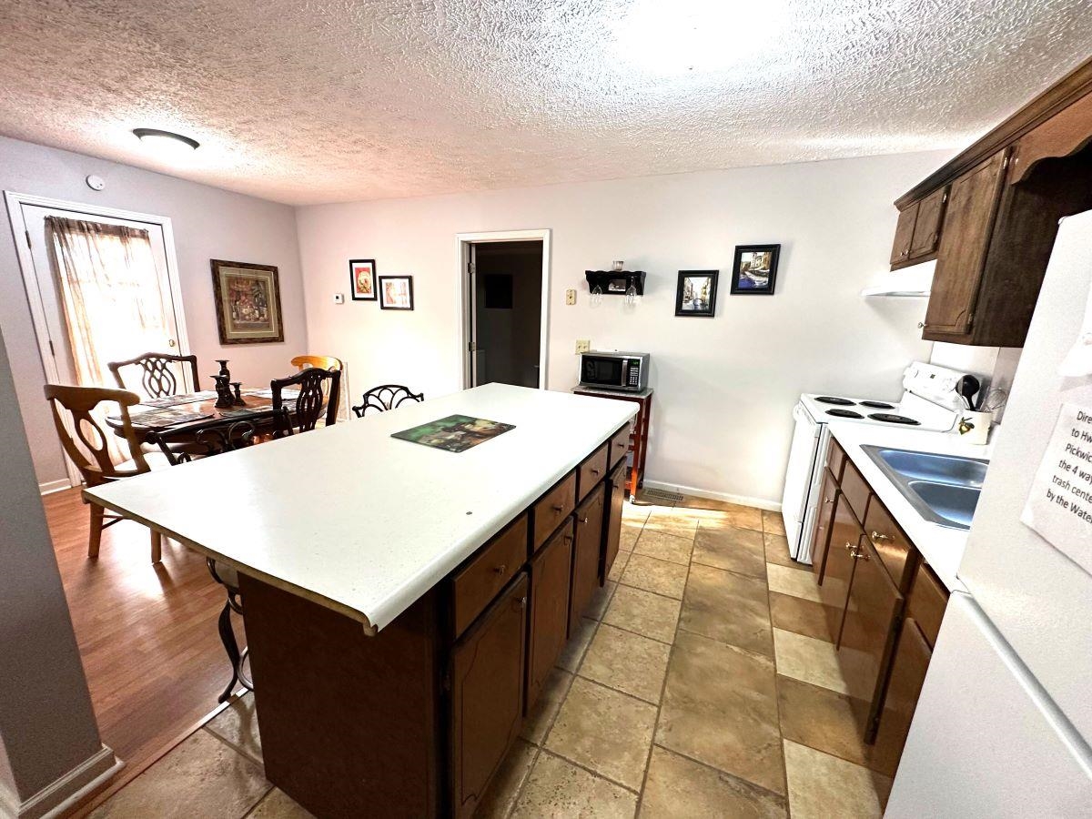 185 Wayson Road Counce, TN 38326 - Photo 10 of 16 a kitchen with a sink stove and refrigerator