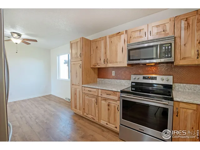 a kitchen with stainless steel appliances a stove a microwave and cabinets