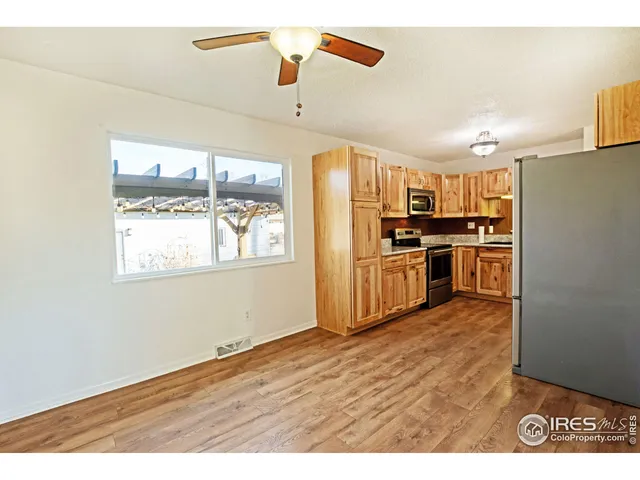 a kitchen with kitchen island a counter space a sink appliances and cabinets