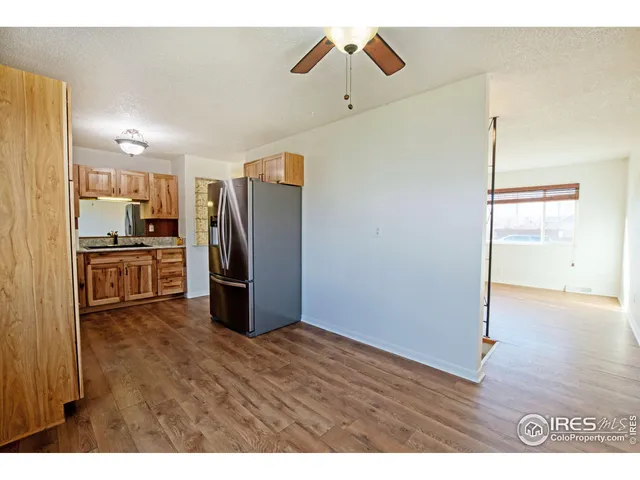 a kitchen with kitchen island stainless steel appliances a refrigerator and cabinets