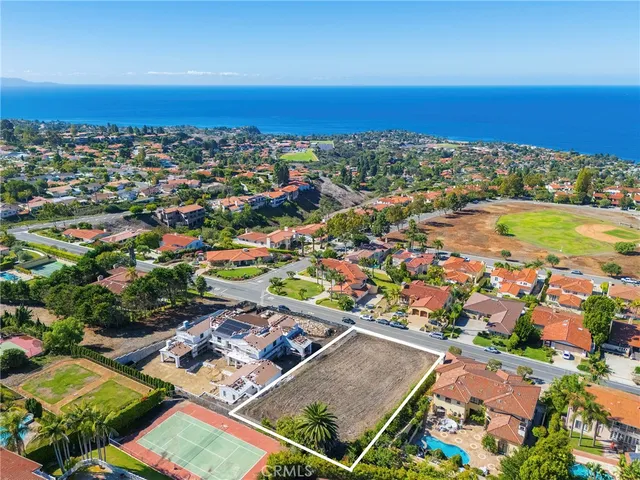 an aerial view of residential building and ocean