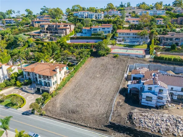 an aerial view of multiple houses with yard