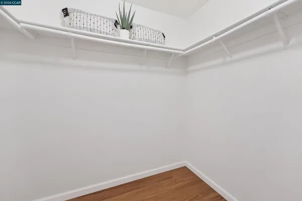 a view of a small space with wooden floor and a window