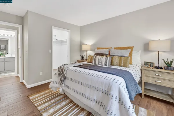 a bedroom with a bed and wooden floor