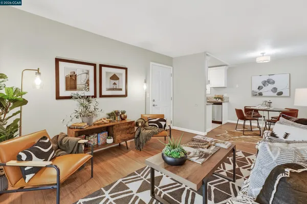 a living room with furniture kitchen view and a dining table