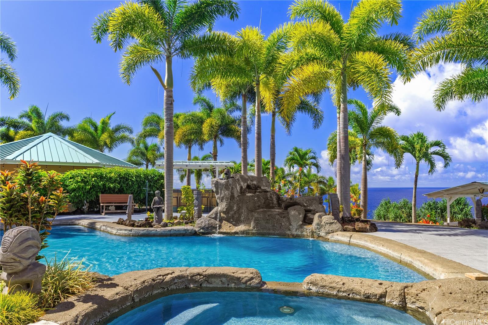 31-212 Hawaii Belt Road Hakalau, HI 96710 - Photo 15 of 25 The pool features an impressive private waterfall, creating a dramatic and captivating focal point that enhances the resort-like atmosphere