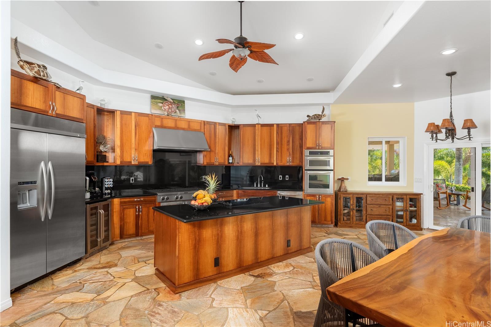 31-212 Hawaii Belt Road Hakalau, HI 96710 - Photo 7 of 25 Spacious open kitchen featuring rich wood cabinetry and elegant granite countertops