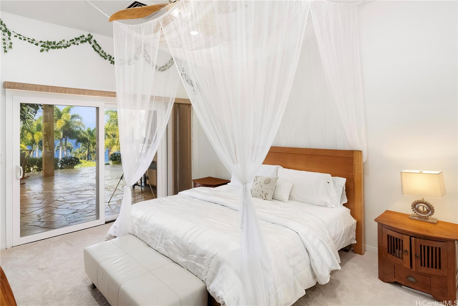 31-212 Hawaii Belt Road Hakalau, HI 96710 - Photo 10 of 25 Additional bedroom in the main house with an adjoining bathroom, ocean views, and private access to a spacious terrace