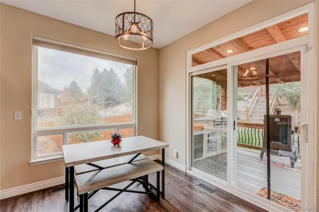a view of a dining room with furniture wooden floor and a chandelier