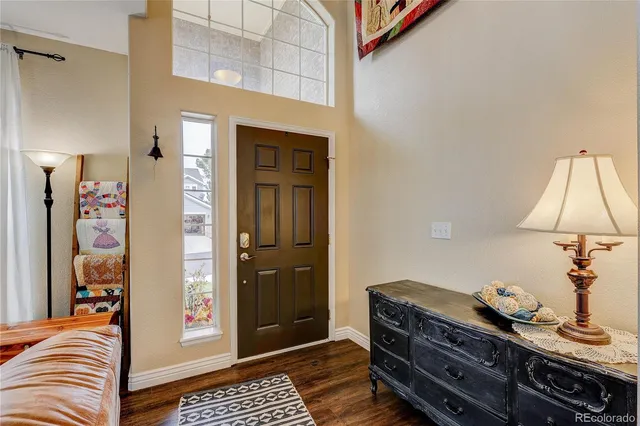 a bedroom with a bed and a lamp on the dresser
