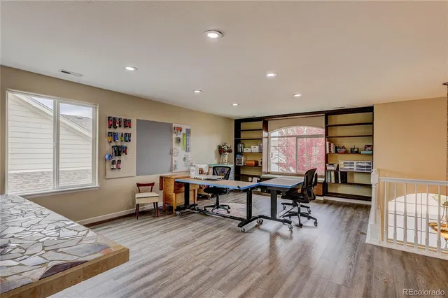 a view of a workspace with furniture and a window
