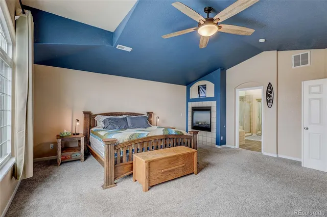 a bedroom with a bed and a ceiling fan