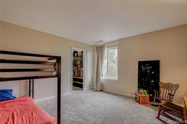 a view of bedroom with furniture and a window
