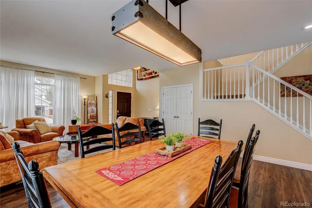 a dining room with furniture a rug and wooden floor
