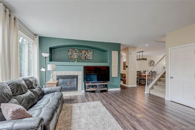 a living room with furniture flat screen tv and a fireplace