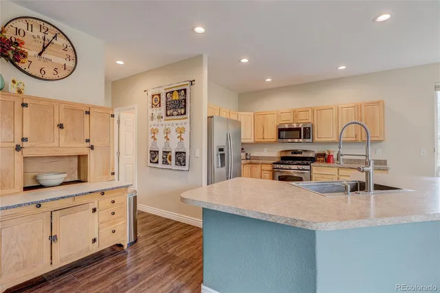 a kitchen with stainless steel appliances a microwave a stove and a refrigerator
