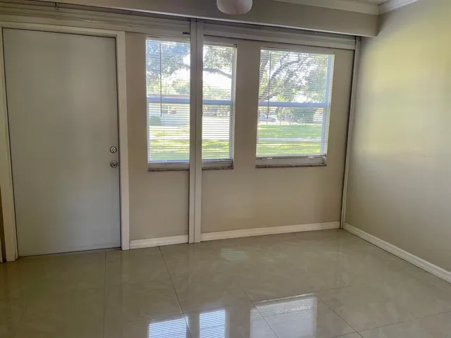a bathroom with a granite countertop toilet sink and mirror
