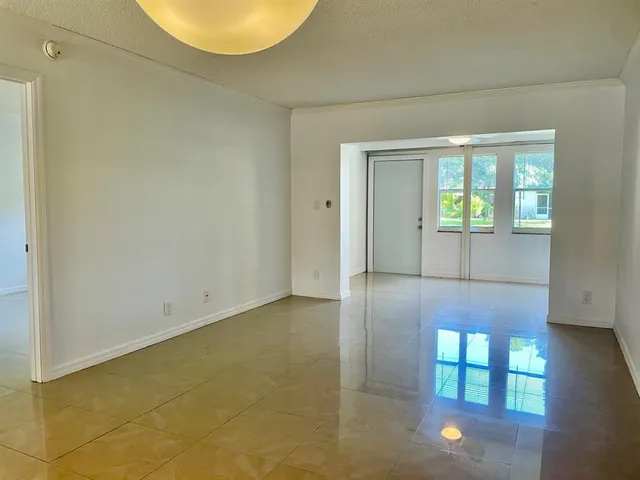a view of a kitchen with a sink and chandelier