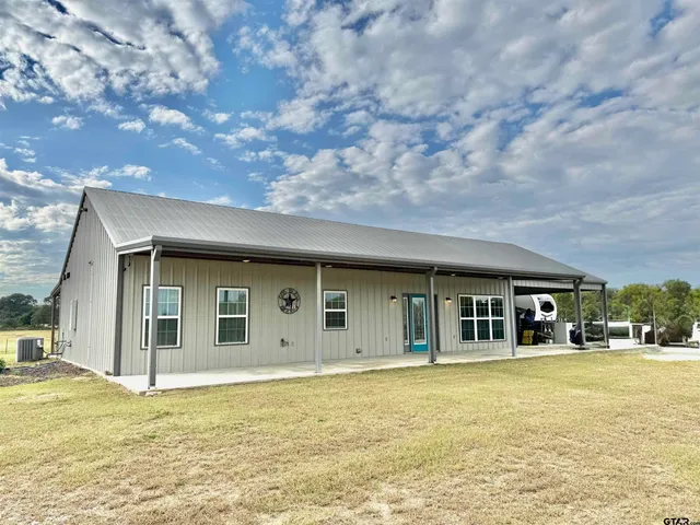 a house with swimming pool in front of it