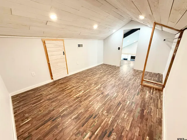 a view of hallway with wooden floor and staircase