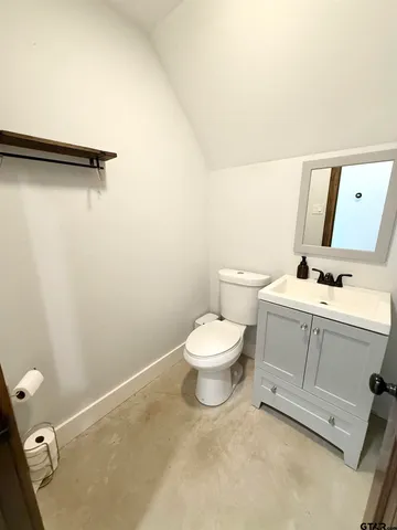 a white toilet sitting next to a bathroom sink