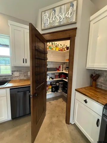 a kitchen with a refrigerator and a sink