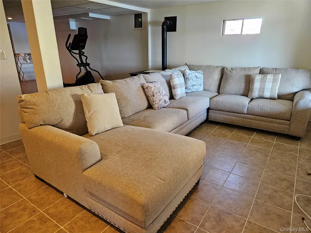 a living room with a couch and a rug