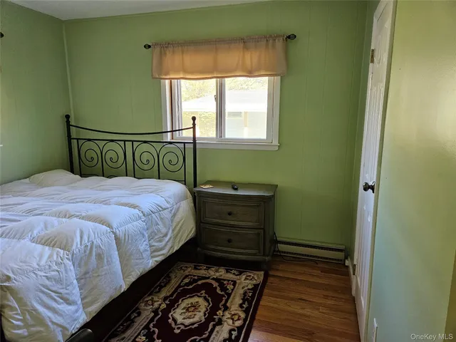 a bed sitting in a bedroom next to a window