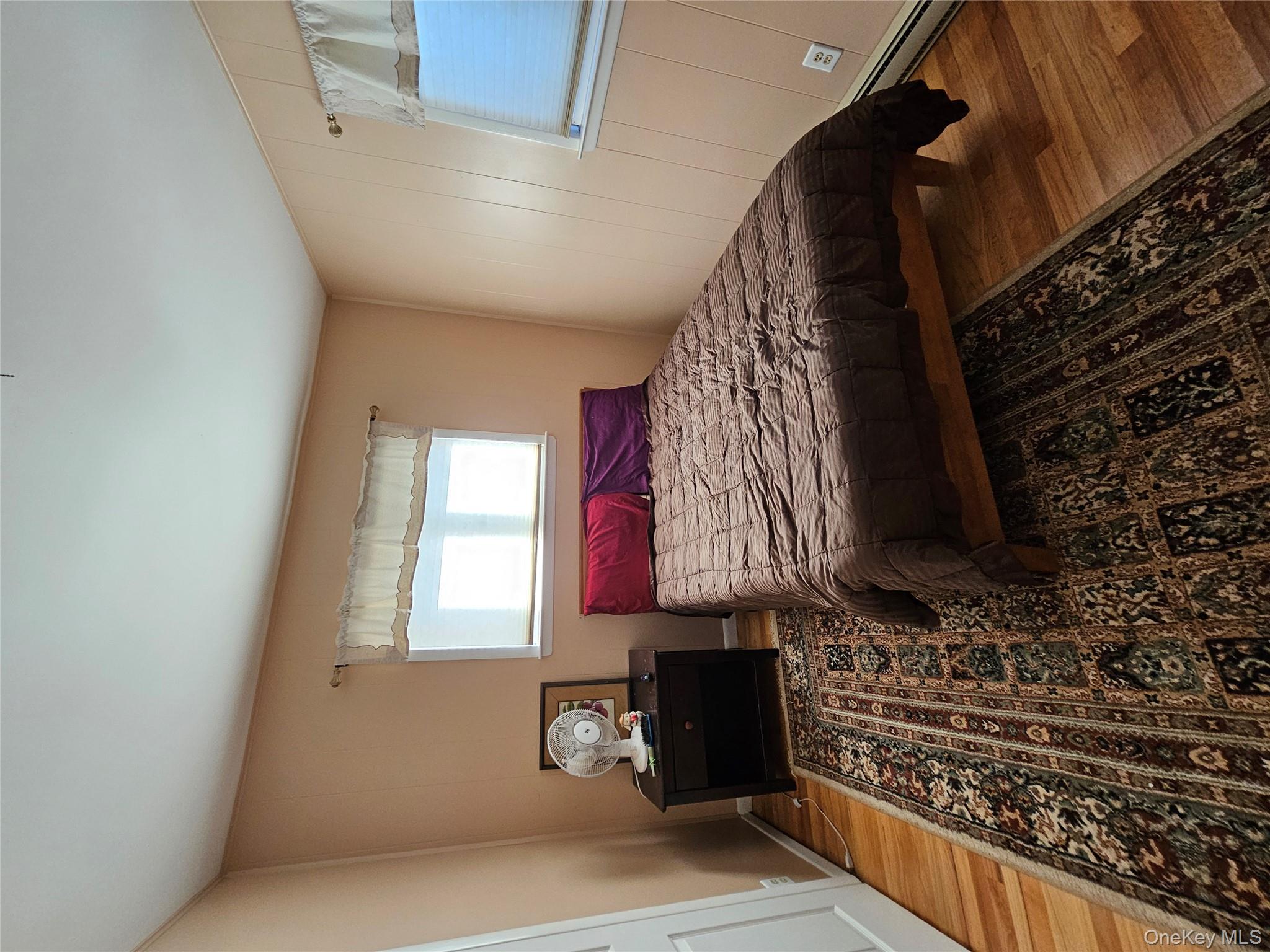 72 Crescent Circle Rock Hill, NY 12775 - Photo 10 of 15 a bedroom with a bed and wooden floor