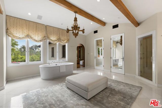 a view of a patio with couches and a large tree