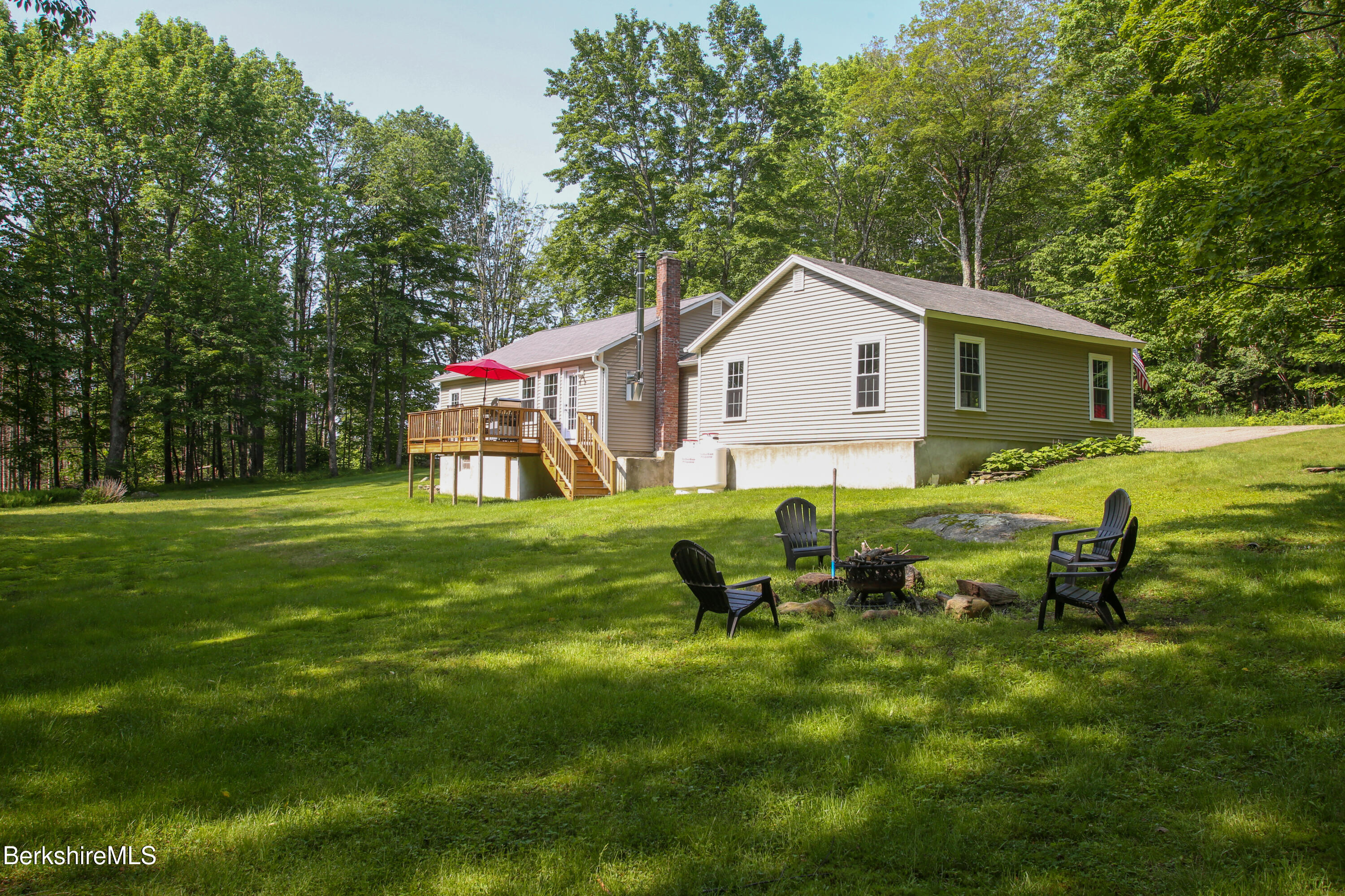 127 County Road Rowe, MA 01367 - Photo 4 of 29 a backyard of a house with table and chairs
