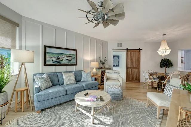 a living room with furniture and a wooden floor
