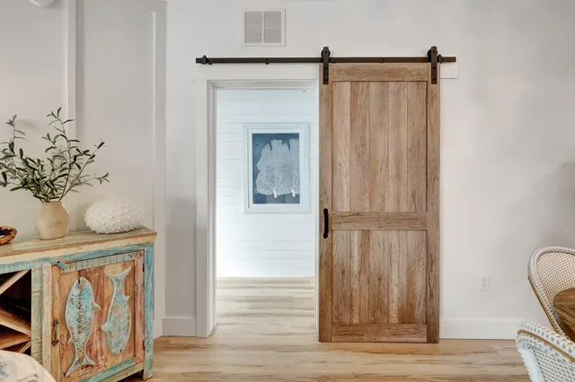 a view of a hallway with wooden floor and staircase