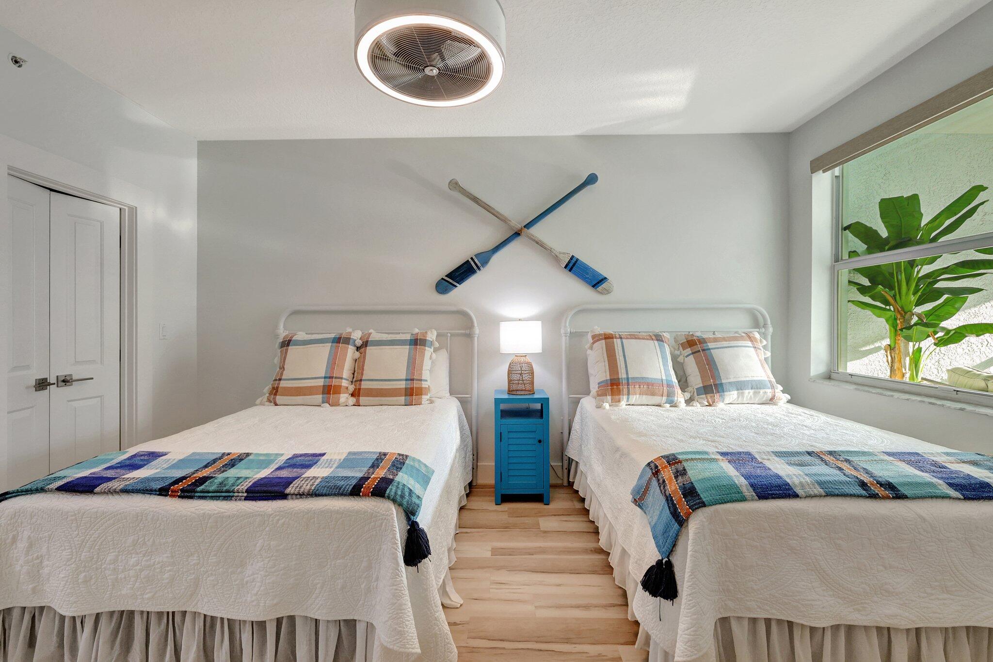 875 Northwest Flagler Avenue, Unit 404 Stuart, FL 34994 - Photo 22 of 56 a bedroom with a bed and a large window