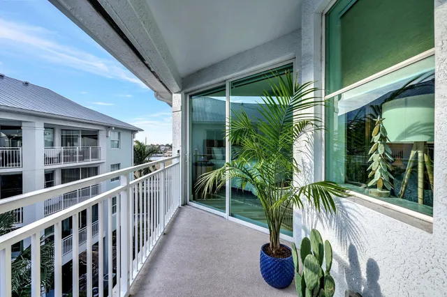 a view of a house with a yard and potted plants