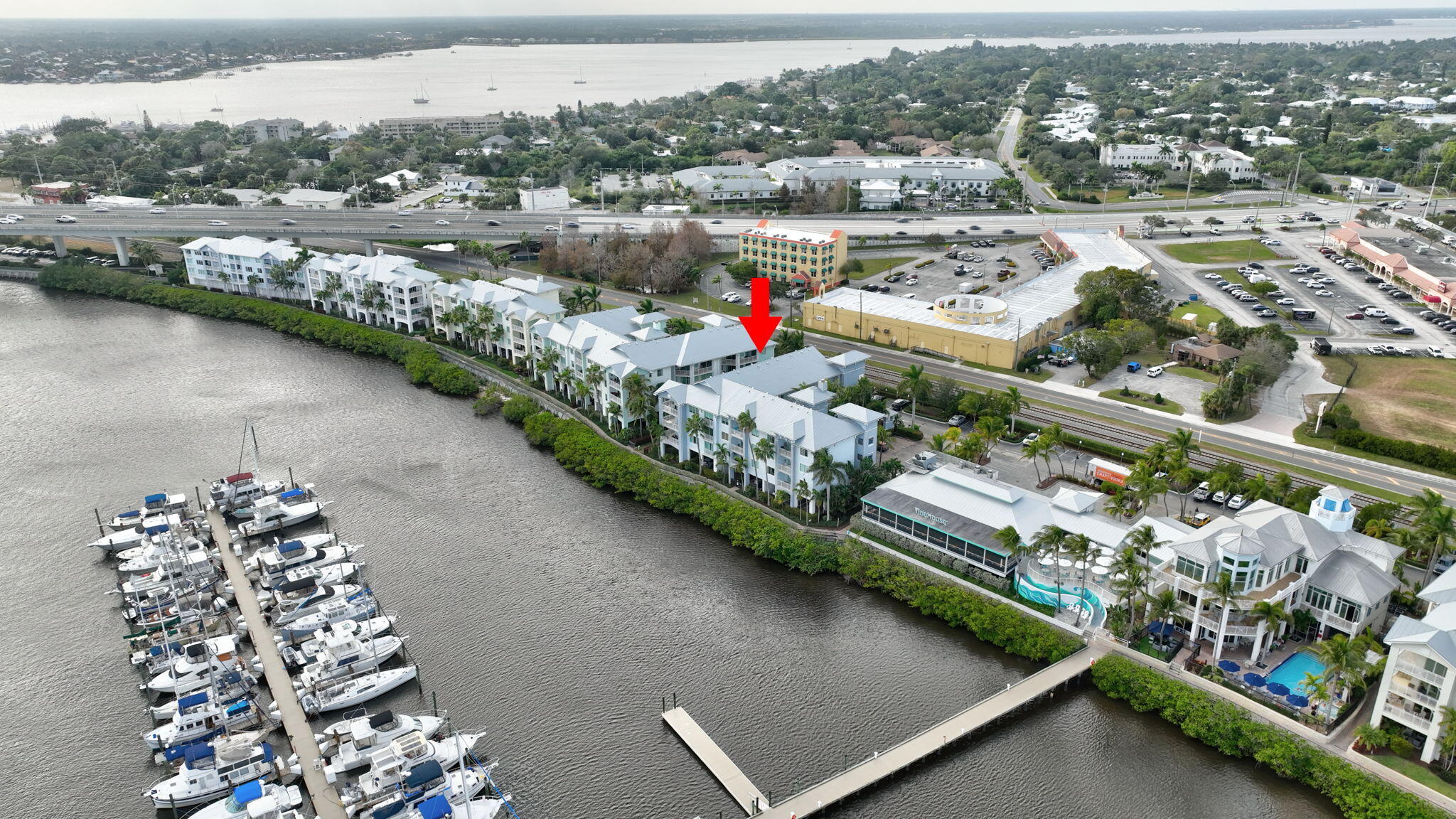 875 Northwest Flagler Avenue, Unit 404 Stuart, FL 34994 - Photo 49 of 56 an aerial view of lake residential house with outdoor space