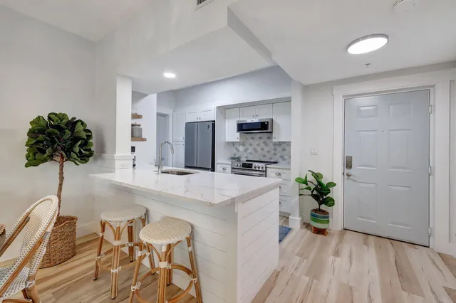 a kitchen with sink and refrigerator
