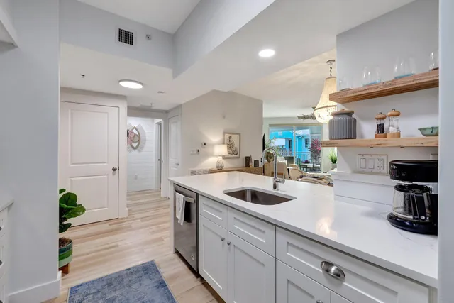 a kitchen with a sink a counter space and stainless steel appliances