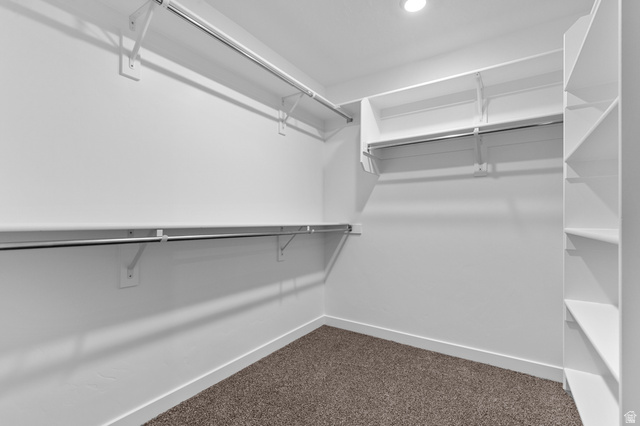 2829 North 710 West, Unit 15 Logan, UT 84321 - Photo 19 of 23 Spacious walk-in closet featuring white built-in shelving, chrome hanging rods, and recessed lighting