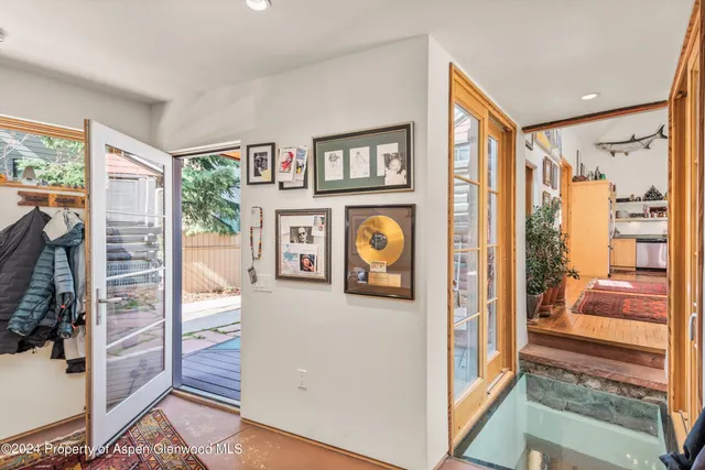 a view of a hallway with a dining table & cabinets