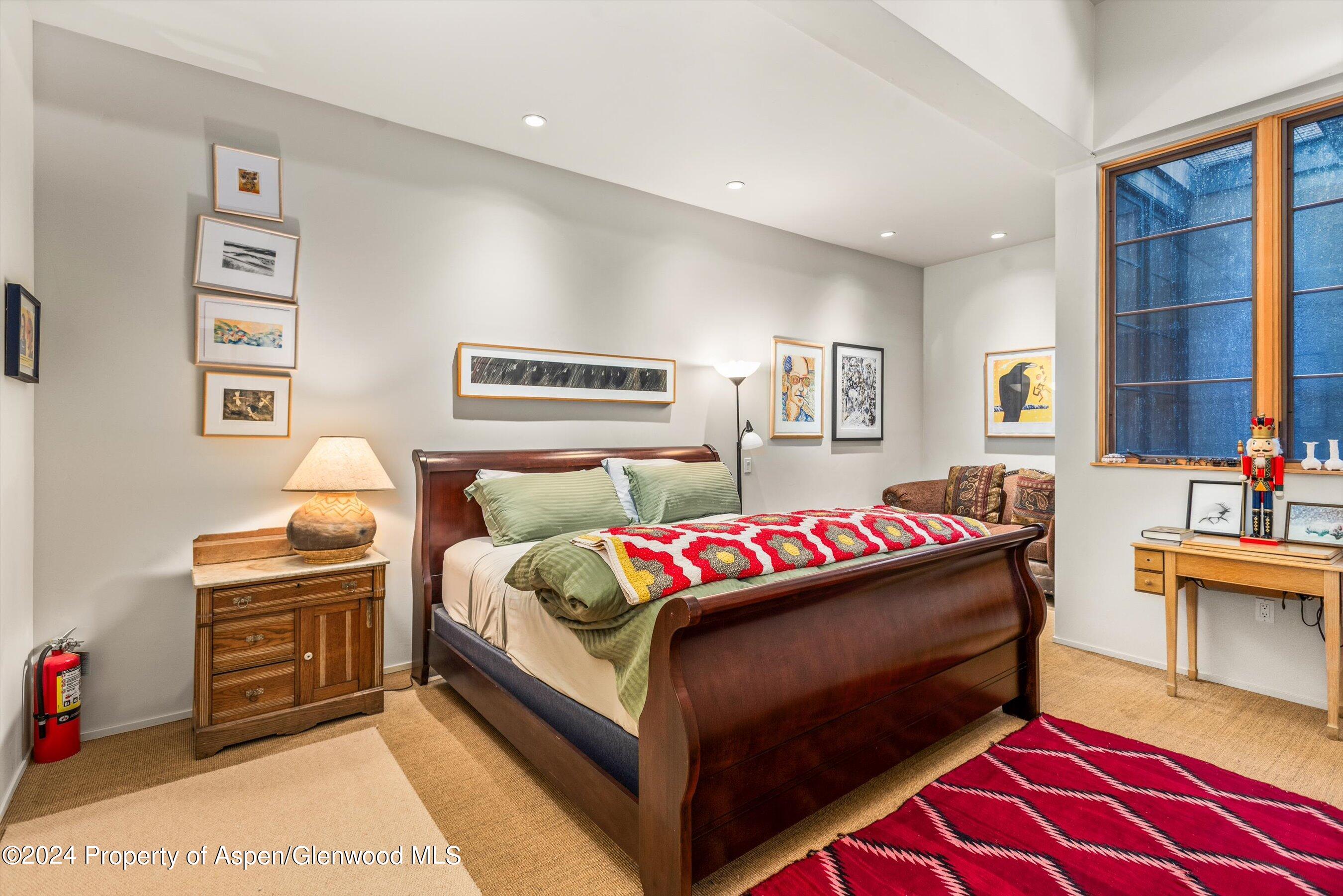 308 Park Avenue Aspen, CO 81611 - Photo 16 of 26 a bedroom with a bed and a couch