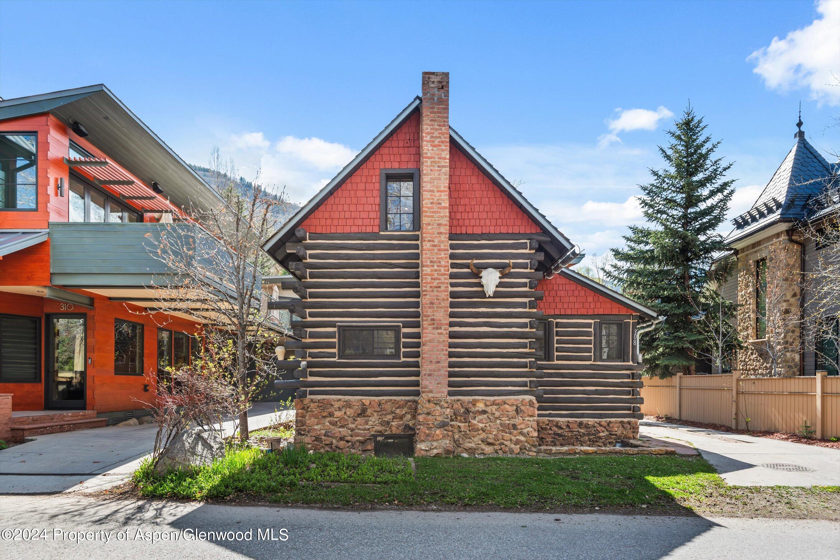 308 Park Avenue Aspen, CO 81611 - Photo 2 of 26 a view of a house with a yard and table and chair under an umbrella